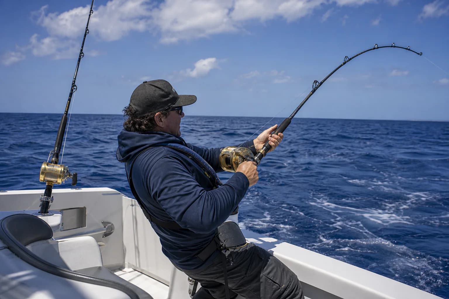 Angler controlling a reel from a working boat position